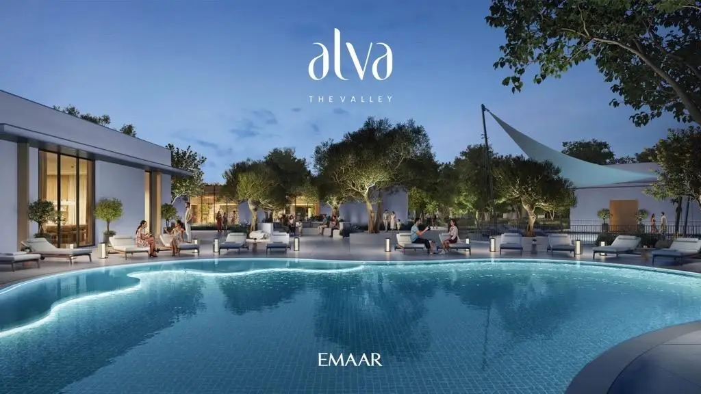 Community pool at dusk: residents on loungers beside a lagoon-shaped pool