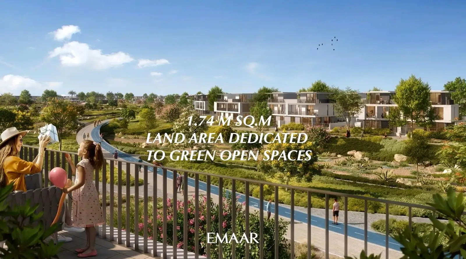 Green open space between townhouses with a family on a balcony